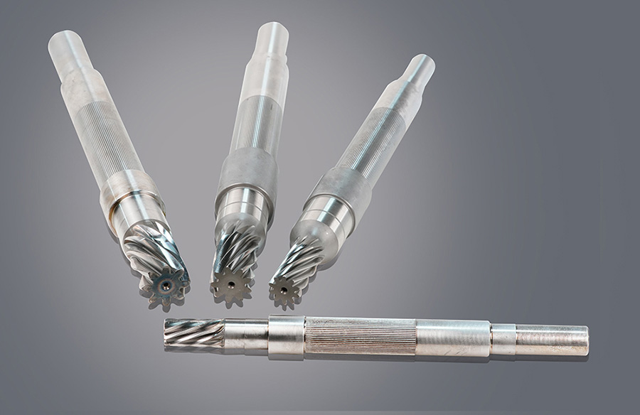 Close-up of metal tool shafts with spiral fluted tips on a cool grey background, industrial and precise mood